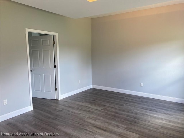 3900 Santiago St, Sebring, FL 33872 - empty room featuring baseboards and dark wood finished floors