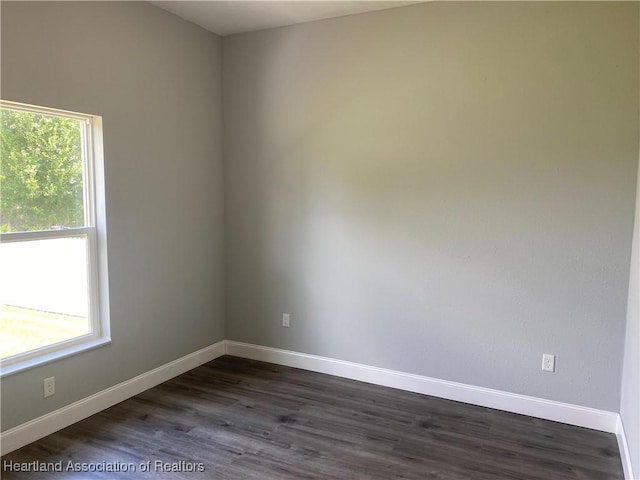 3900 Santiago St, Sebring, FL 33872 - empty room featuring dark wood finished floors and baseboards