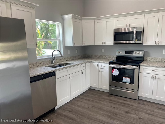 3900 Santiago St, Sebring, FL 33872 - kitchen featuring stainless steel appliances, white cabinetry, and light stone counters