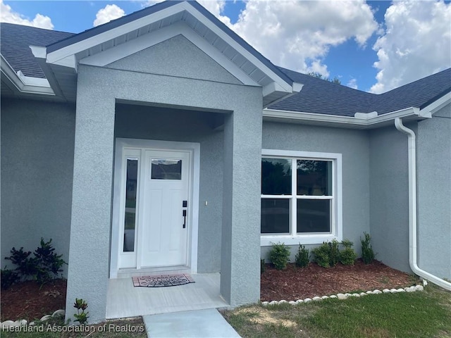 3900 Santiago St, Sebring, FL 33872 - entrance to property featuring stucco siding and a shingled roof