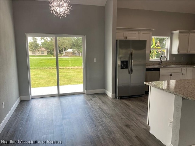 3900 Santiago St, Sebring, FL 33872 - kitchen featuring stainless steel appliances, dark wood-type flooring, white cabinets, and light stone countertops