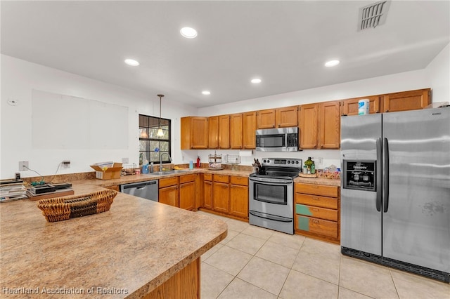 5324 Lafayette Ave, Sebring, FL 33875 - kitchen featuring brown cabinets, a sink, stainless steel appliances, decorative light fixtures, and visible vents