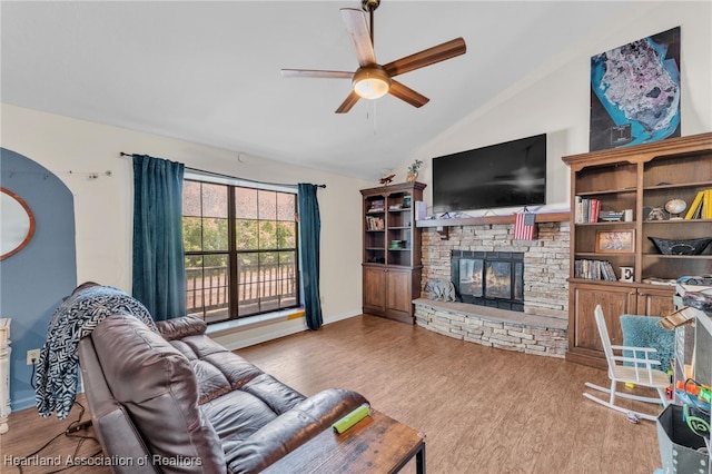 5324 Lafayette Ave, Sebring, FL 33875 - living room with a stone fireplace, a ceiling fan, wood finished floors, and vaulted ceiling