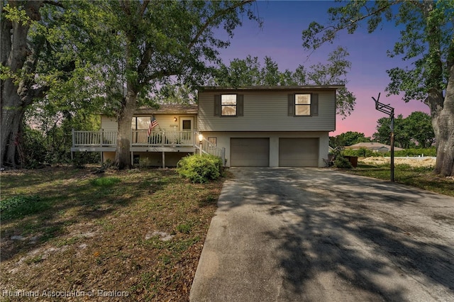 5324 Lafayette Ave, Sebring, FL 33875 - split level home with stairs, a garage, aphalt driveway, and a deck