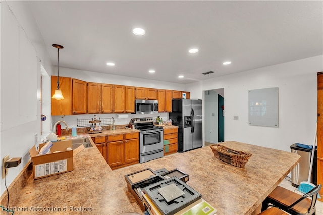 5324 Lafayette Ave, Sebring, FL 33875 - kitchen with a kitchen breakfast bar, visible vents, appliances with stainless steel finishes, light countertops, and a sink