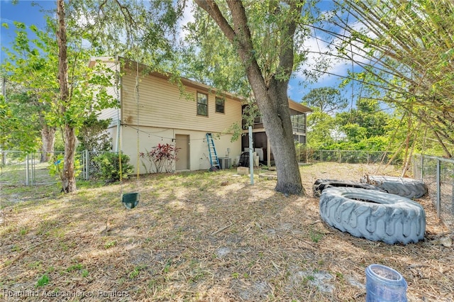 5324 Lafayette Ave, Sebring, FL 33875 - back of house with central AC and a fenced backyard
