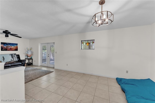 5324 Lafayette Ave, Sebring, FL 33875 - unfurnished living room featuring baseboards, ceiling fan with notable chandelier, light tile patterned floors, and french doors