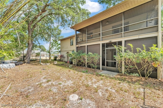 5324 Lafayette Ave, Sebring, FL 33875 - rear view of property with a sunroom
