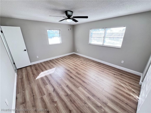 unfurnished bedroom with a textured ceiling, ceiling fan, and light hardwood / wood-style flooring