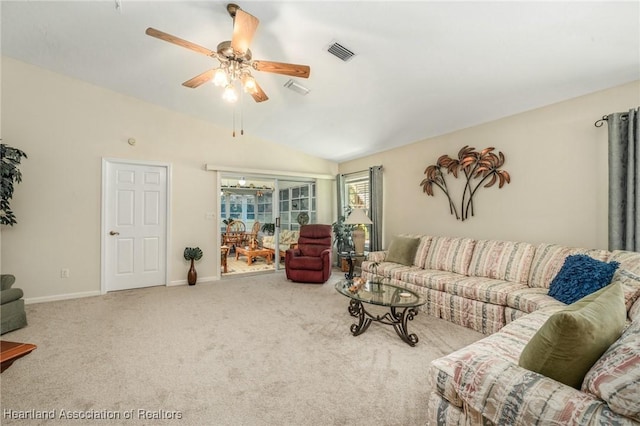 living room with lofted ceiling, ceiling fan, and carpet