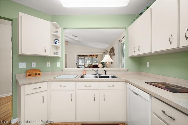 kitchen featuring white cabinetry, lofted ceiling, white dishwasher, and sink