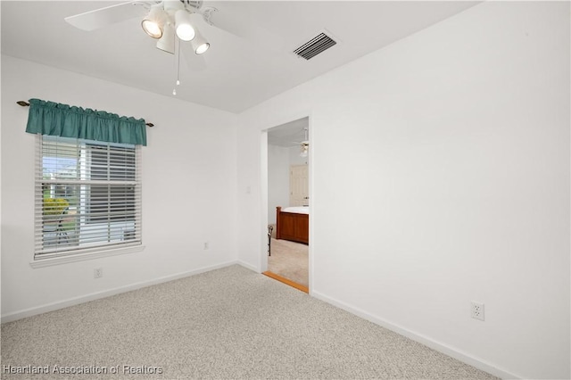 carpeted empty room featuring ceiling fan