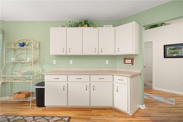 kitchen featuring light hardwood / wood-style flooring and white cabinets