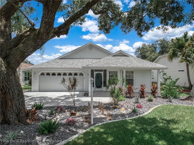 single story home with a garage, a porch, and a front yard