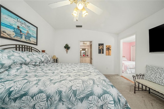 carpeted bedroom featuring lofted ceiling, ceiling fan, and ensuite bathroom