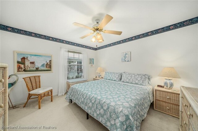 bedroom featuring ceiling fan and light colored carpet