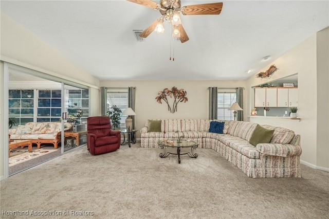 living room featuring carpet floors, vaulted ceiling, and ceiling fan