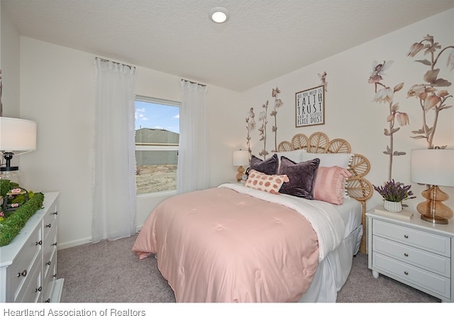 carpeted bedroom with a textured ceiling