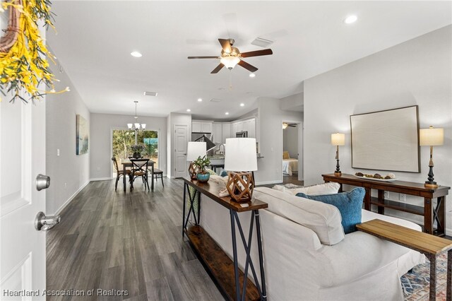 9131 Canter Path, Sebring, FL 33875 - living area with a ceiling fan, dark wood-style flooring, recessed lighting, and a chandelier