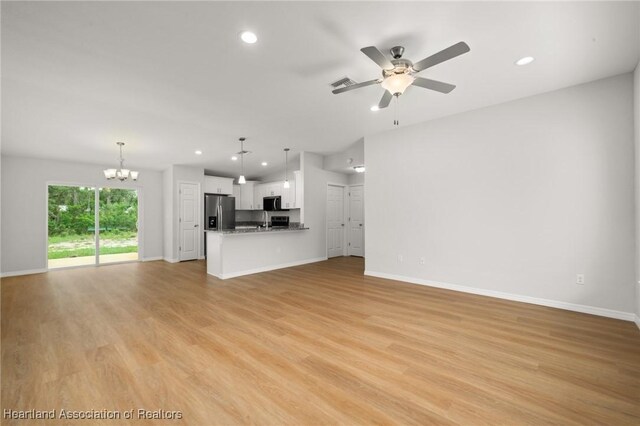 9131 Canter Path, Sebring, FL 33875 - unfurnished living room featuring a chandelier, recessed lighting, light wood finished floors, and ceiling fan