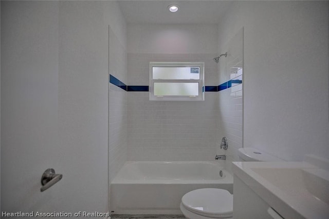 full bathroom with vanity, tiled shower / bath, and toilet