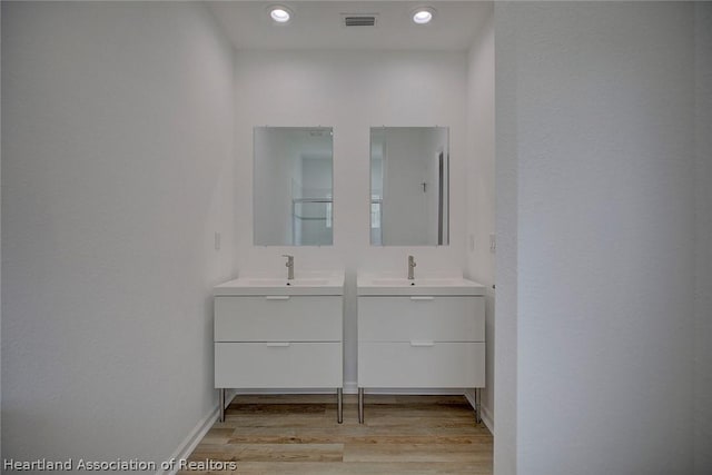 bathroom with vanity and hardwood / wood-style flooring