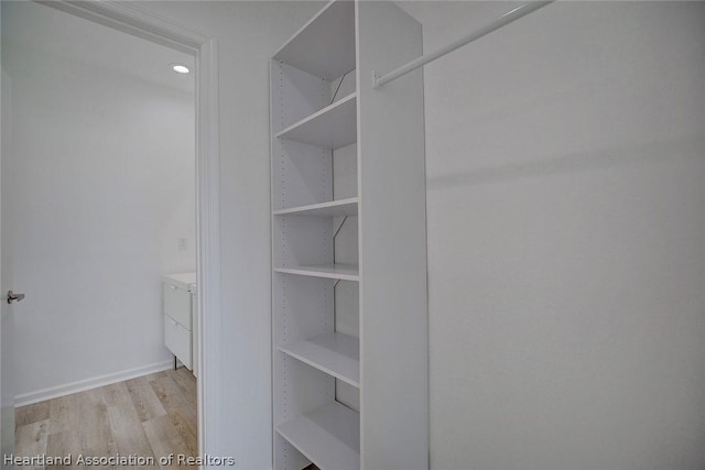 walk in closet with light wood-type flooring