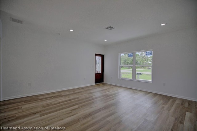 spare room with light hardwood / wood-style floors