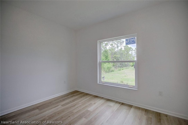 unfurnished room with light wood-type flooring