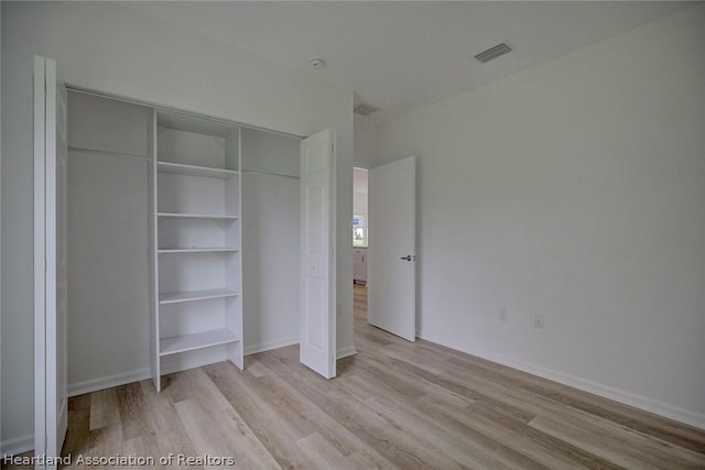 unfurnished bedroom with light wood-type flooring