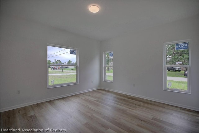 unfurnished room with light hardwood / wood-style flooring