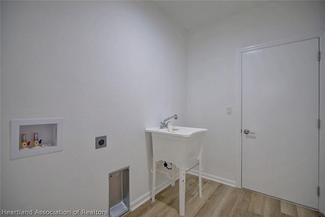 clothes washing area featuring hookup for an electric dryer, light wood-type flooring, and hookup for a washing machine