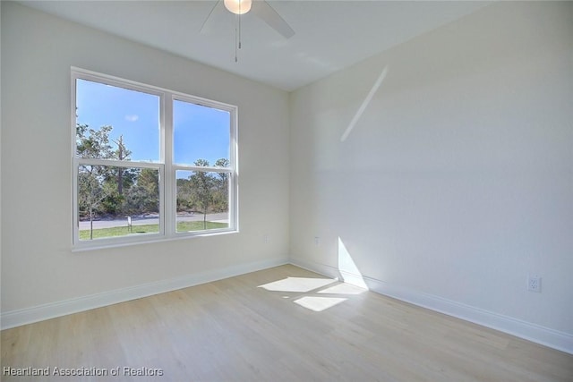 empty room with light hardwood / wood-style flooring and ceiling fan