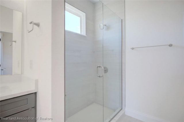 bathroom with vanity and a shower with shower door