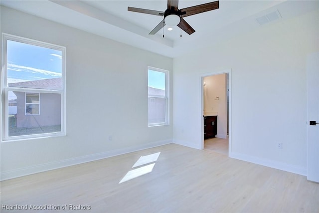 unfurnished room with ceiling fan, plenty of natural light, and light hardwood / wood-style floors