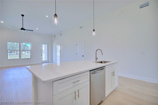 kitchen featuring pendant lighting, white cabinetry, dishwasher, sink, and a kitchen island with sink