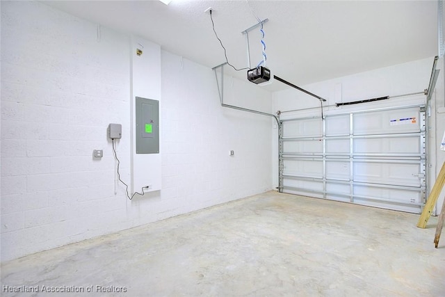 garage with a garage door opener and electric panel