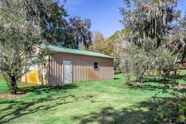 view of outbuilding with a lawn