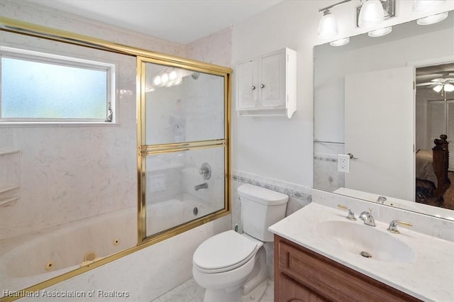 full bathroom with toilet, vanity, and bath / shower combo with glass door