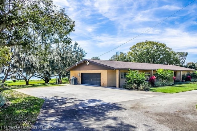 view of front of home featuring a garage and a front lawn