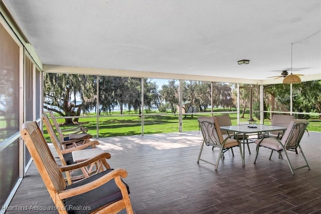 sunroom / solarium featuring ceiling fan