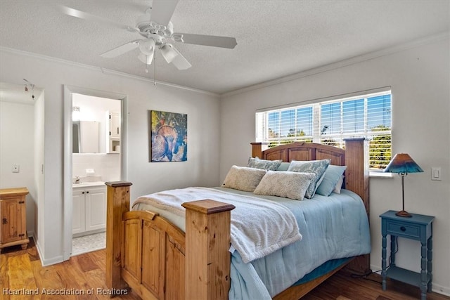 bedroom with crown molding, hardwood / wood-style flooring, and a textured ceiling
