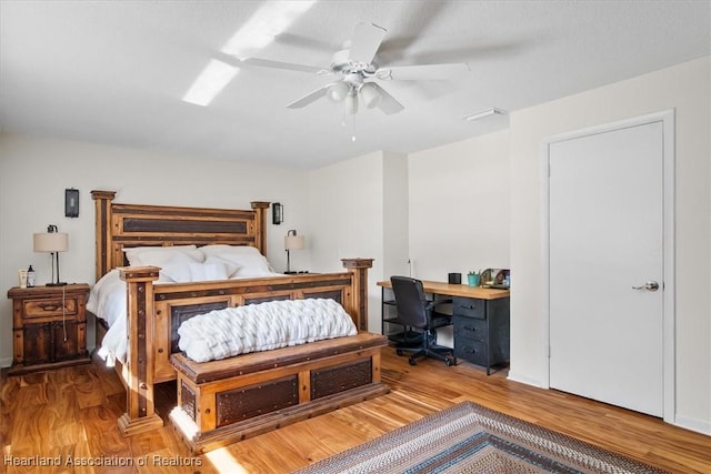 bedroom with light hardwood / wood-style flooring and ceiling fan