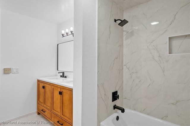 bathroom featuring vanity and tiled shower / bath