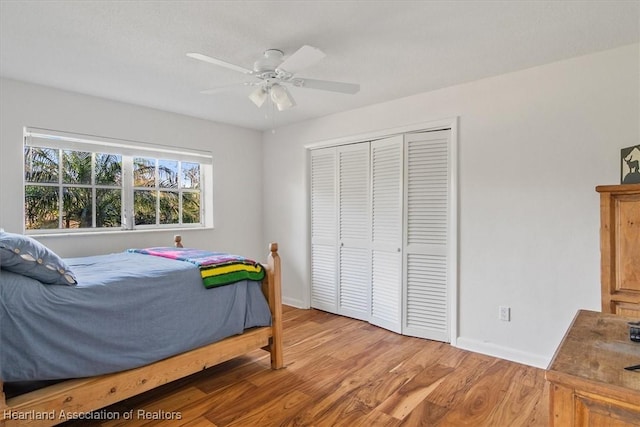 bedroom featuring wood-type flooring, a closet, and ceiling fan