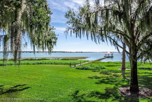 exterior space with a water view and a boat dock
