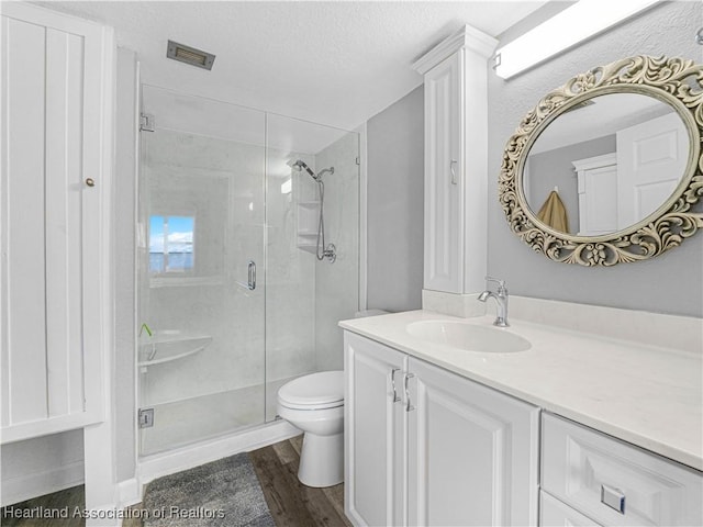 2131 Lakeview Dr Unit 1008, Sebring, FL 33870 - bathroom featuring a stall shower, vanity, wood finished floors, and a textured ceiling