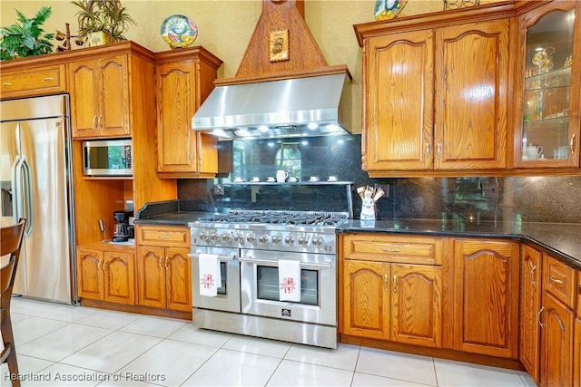 14630 Luray Rd, Southwest Ranches, FL 33330 - kitchen with built in appliances, ventilation hood, brown cabinets, and tasteful backsplash