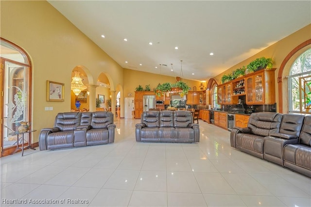 14630 Luray Rd, Southwest Ranches, FL 33330 - living area featuring beverage cooler, decorative columns, light tile patterned floors, recessed lighting, and arched walkways