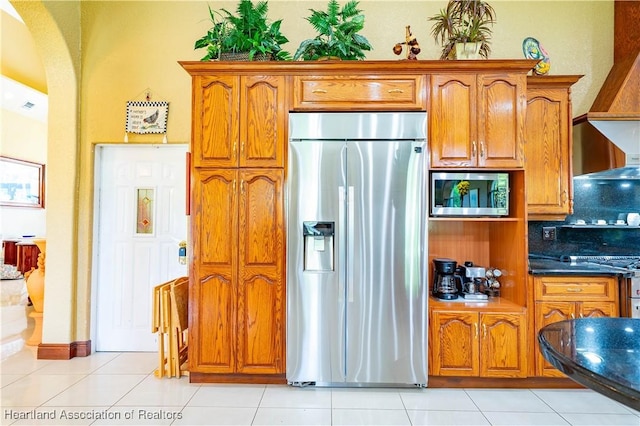 14630 Luray Rd, Southwest Ranches, FL 33330 - kitchen with appliances with stainless steel finishes, arched walkways, brown cabinets, and light tile patterned floors